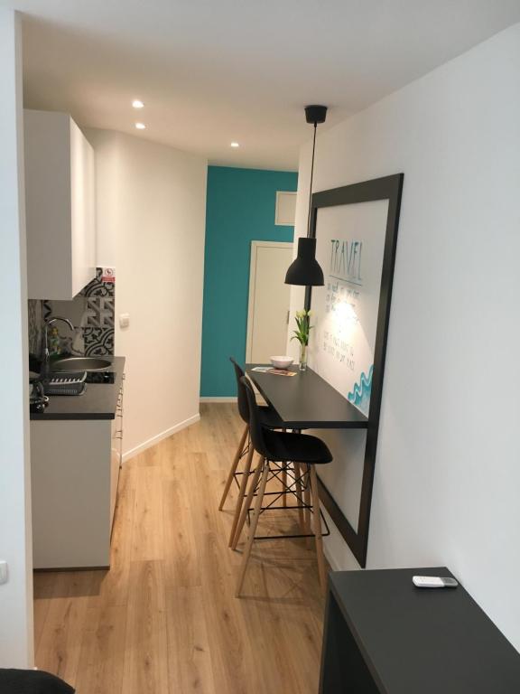 a kitchen and dining room with a table and chairs at Flumen in Rijeka