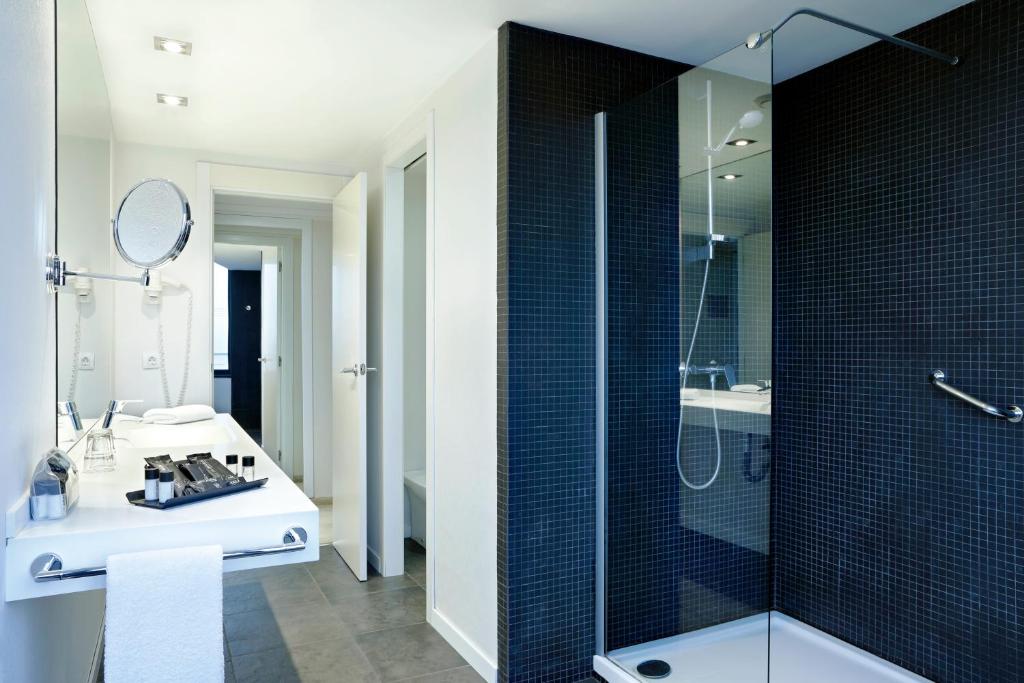 a bathroom with a sink and a glass shower at Hotel Alimara in Barcelona