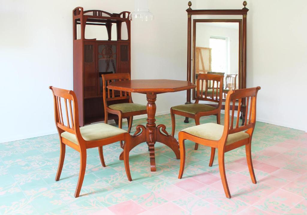 a wooden table and chairs and a mirror at Loreley 110 in Sankt Goar