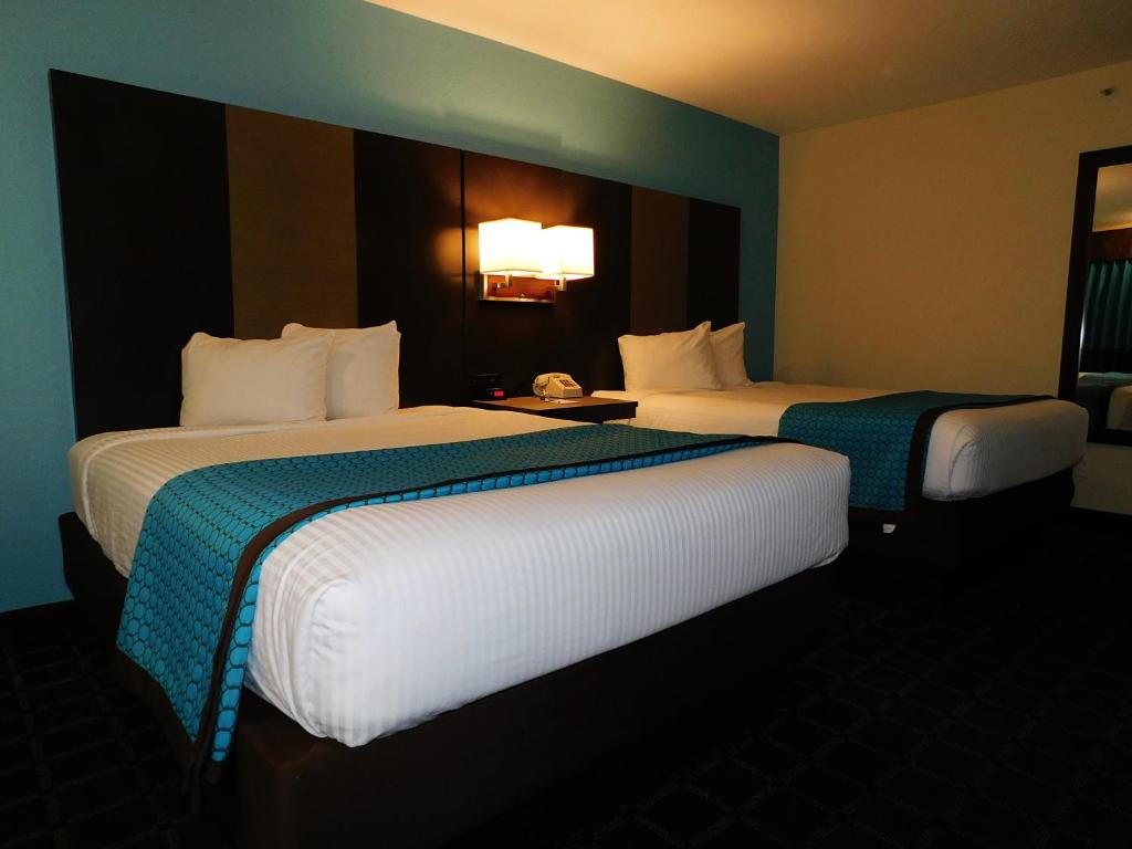 two beds in a hotel room with two at Travelodge by Wyndham Angels Camp CA in Angels Camp