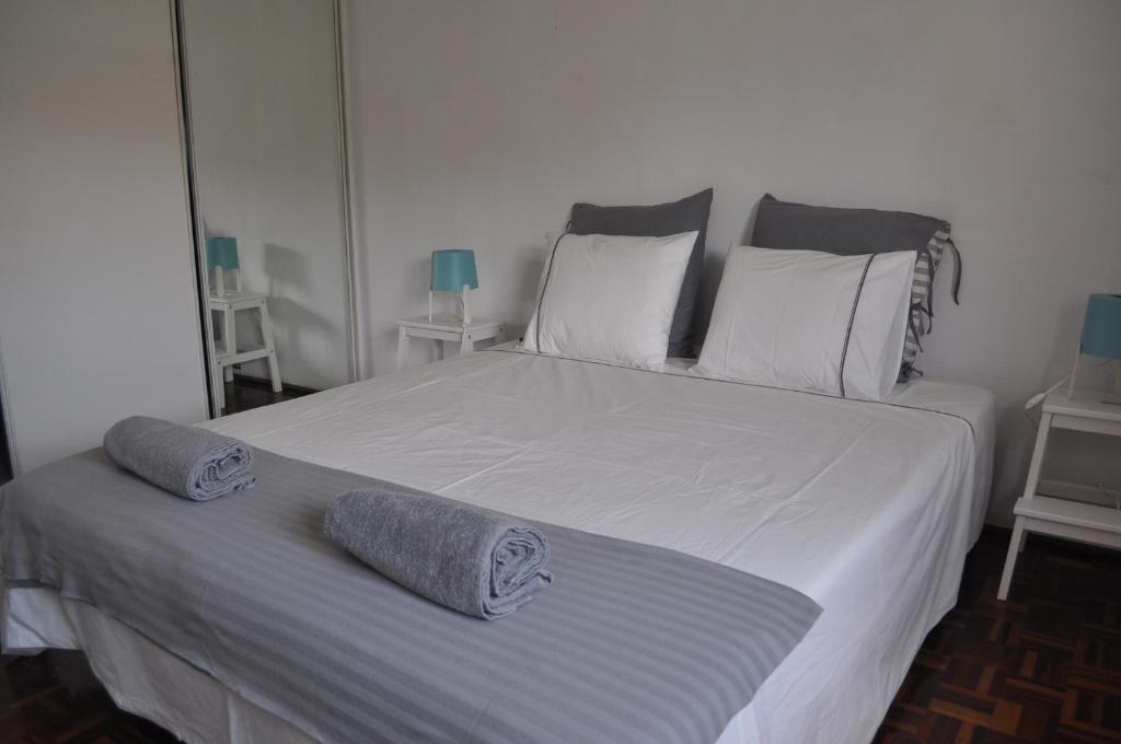 a bedroom with a large bed with two pillows on it at F! Lisbon Guest House in Lisbon