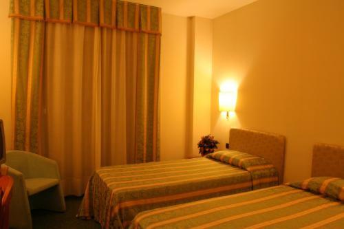 Postel nebo postele na pokoji v ubytování Savant Hotel