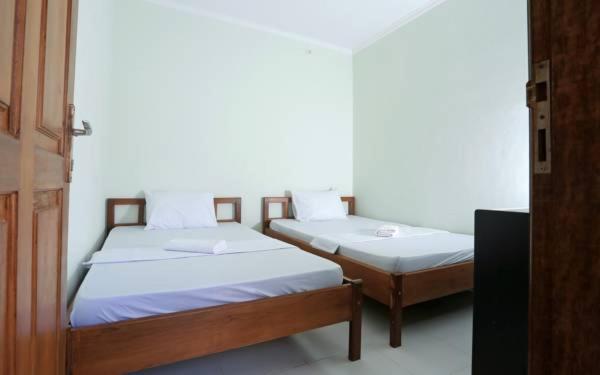 Postel nebo postele na pokoji v ubytování Jazz Senggigi Hotel