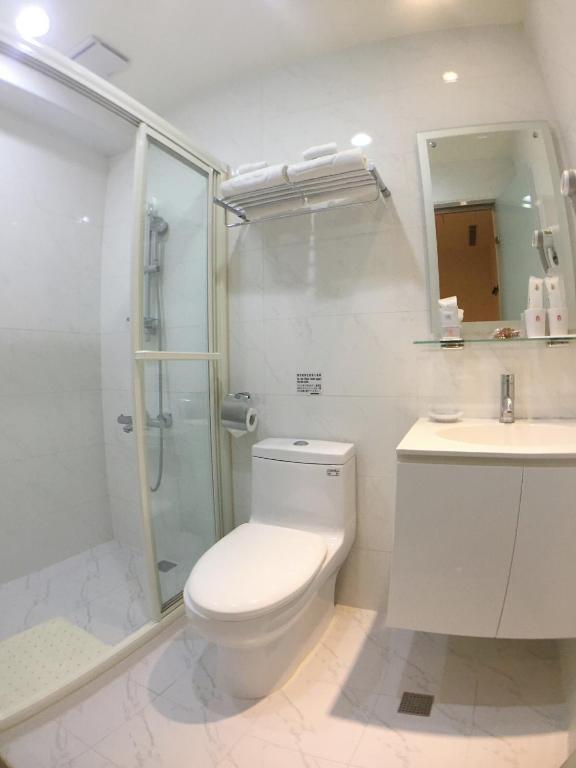 a bathroom with a toilet and a shower and a sink at Royal Hotel in Taipei