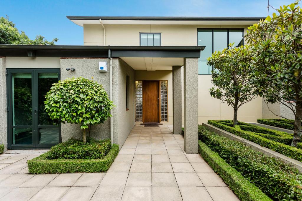 a house with a pathway leading to the front door at Oasis on Belmont Lane in Dunedin