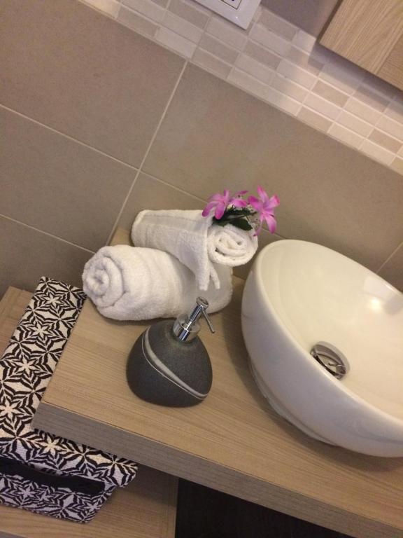 a bathroom with a sink and towels on a counter at Sweet Dreams in San Vito lo Capo