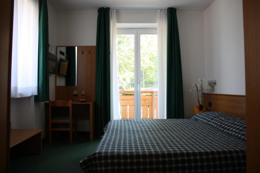 Postel nebo postele na pokoji v ubytování Albergo Miramonti