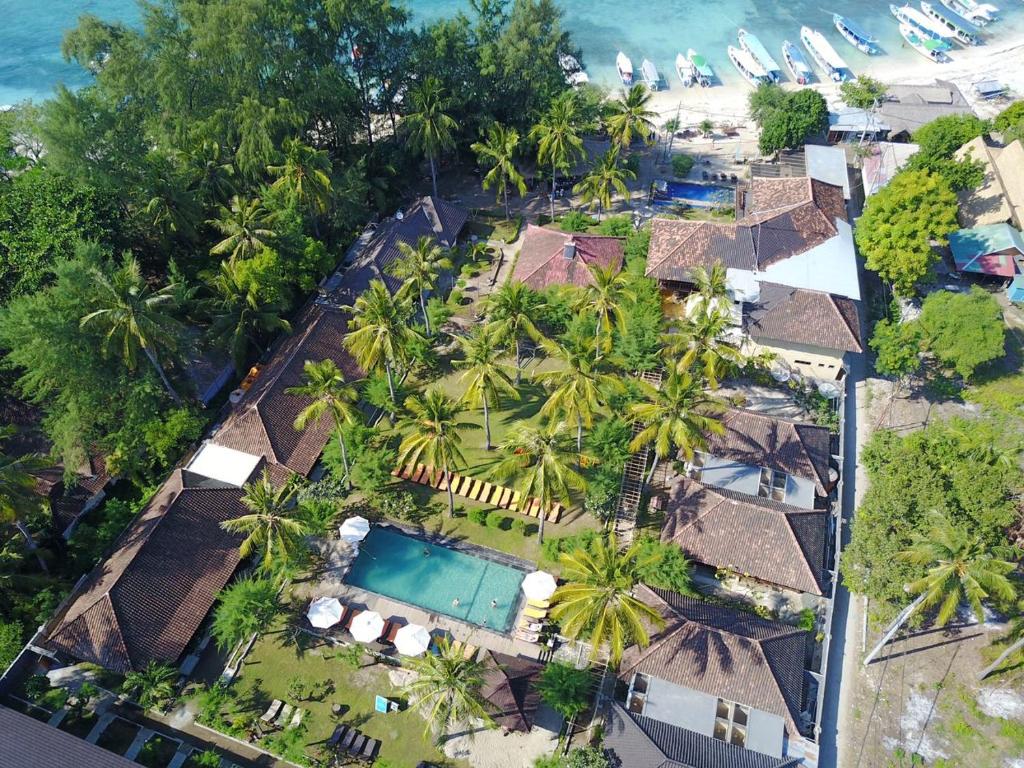 an aerial view of a resort with a pool and palm trees at Royal Regantris Villa Karang in Gili Air