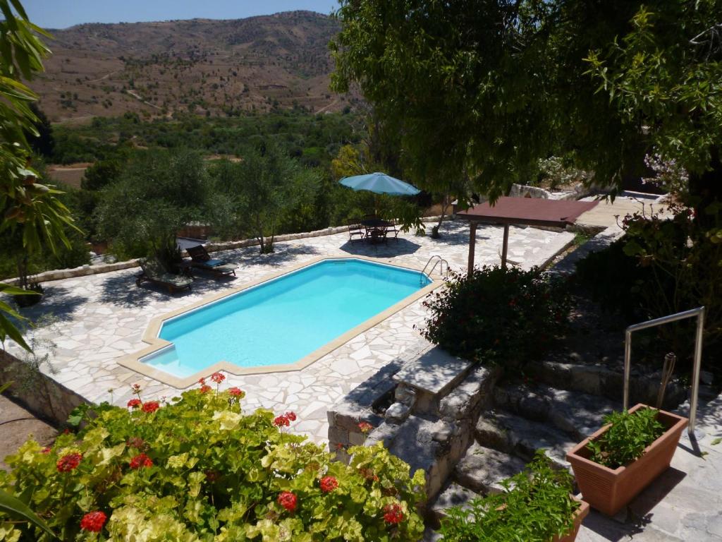 a swimming pool in a garden with a view at Piskopos Country House in Episkopi Pafou