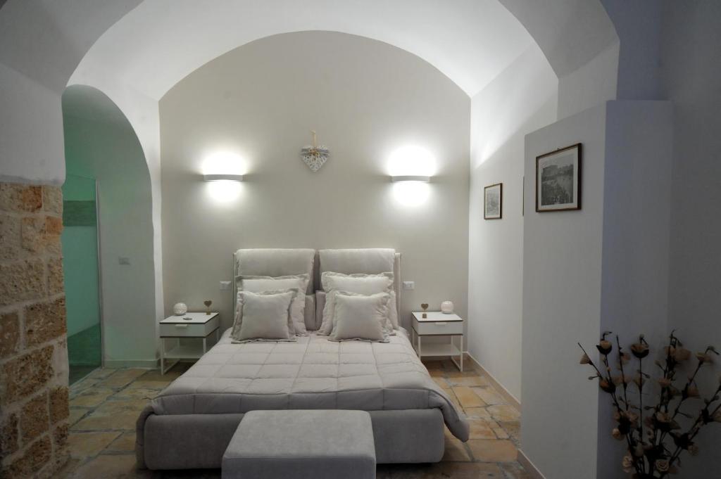 a bedroom with a large bed with two tables at Borgo Martino in Bari