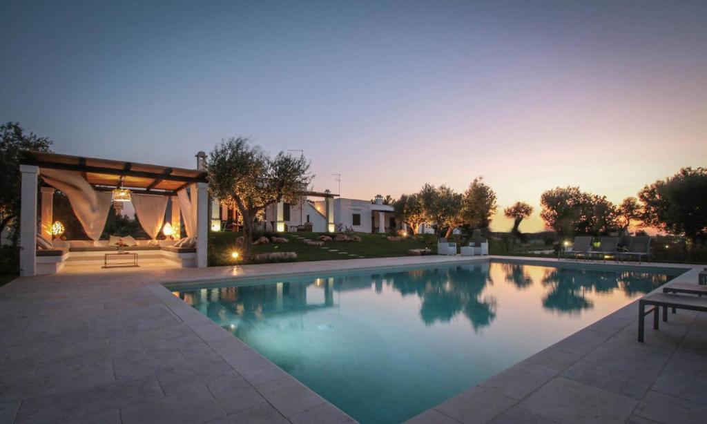 a swimming pool with a gazebo and a house at Villa del Vento in Polignano a Mare