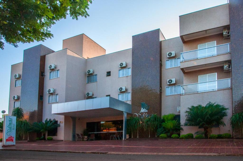 un edificio con un montón de plantas delante de él en Hotel Valencia, en Dourados