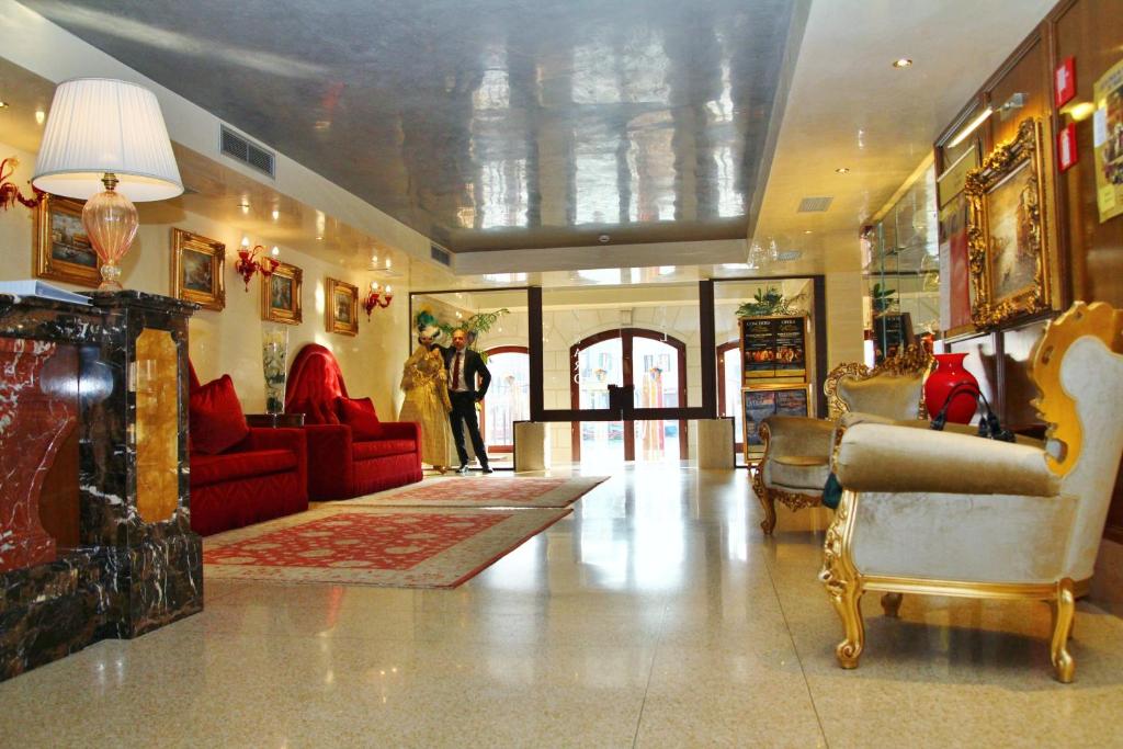 a lobby with couches and chairs in a building at Pesaro Palace in Venice