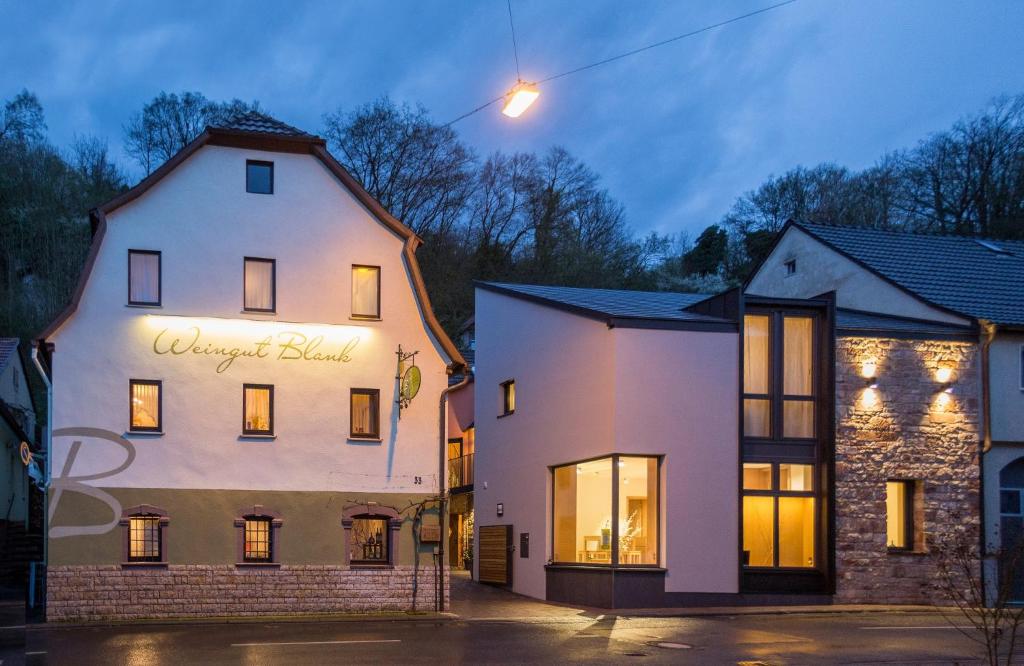 a white building with a sign on the side of it at Weingut Blank in Homburg