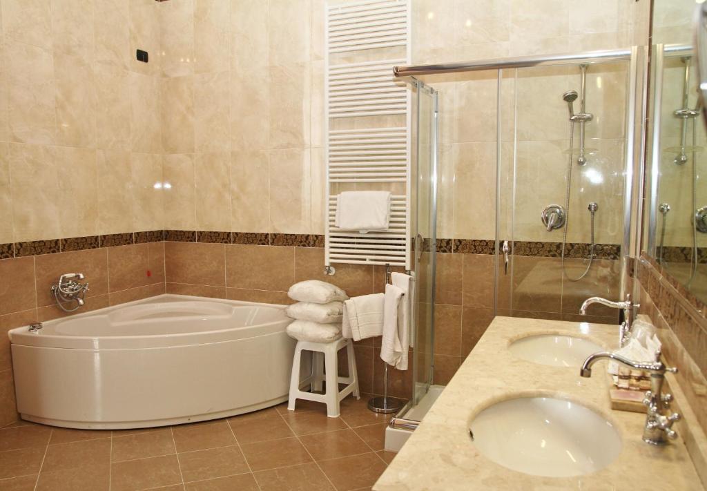 a bathroom with a tub and a sink at Pesaro Palace in Venice