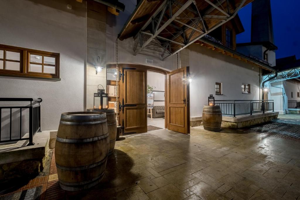 a room with two wooden barrels in a building at Hotel Vinnica in Wieliczka