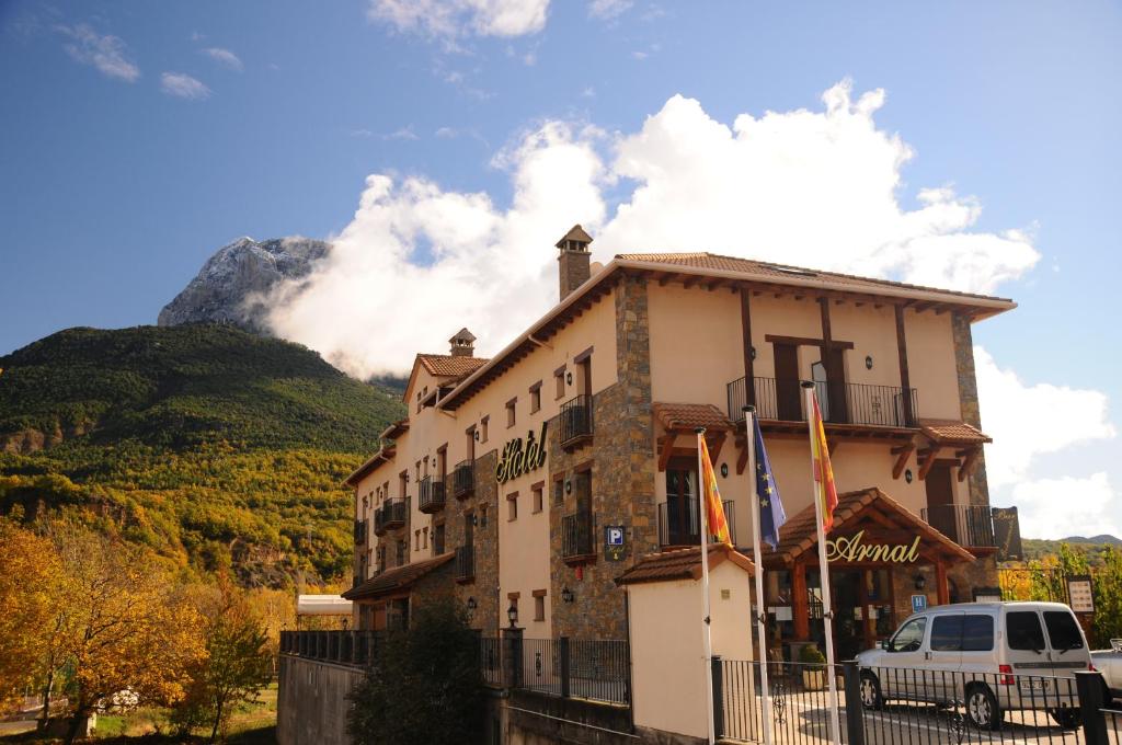 a building with a mountain in the background at Hotel Arnal in Escalona
