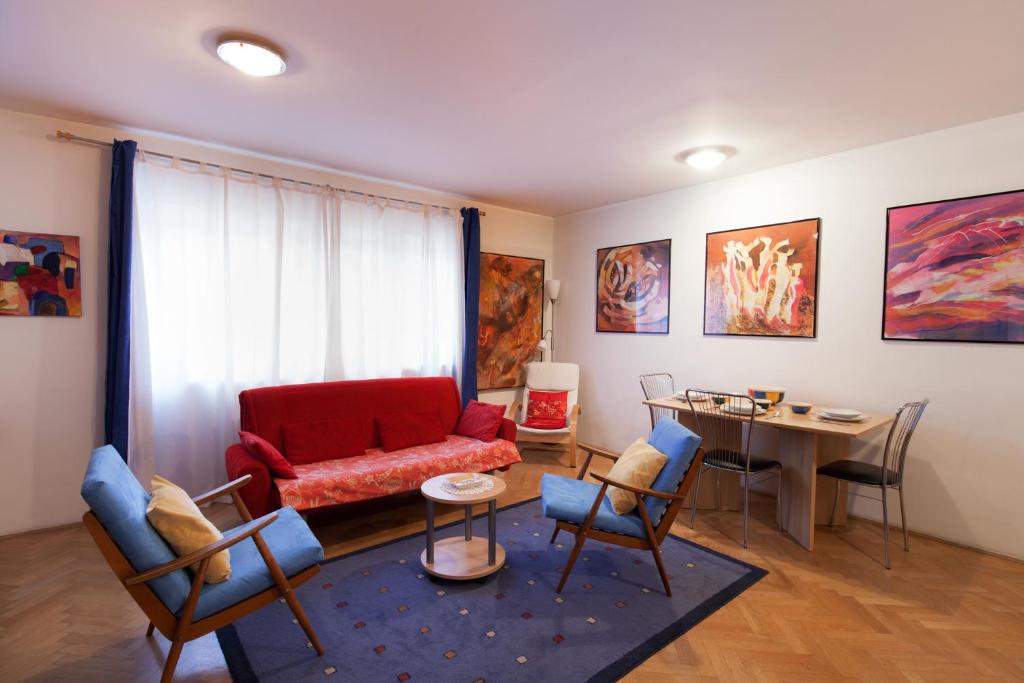 uma sala de estar com um sofá vermelho e uma mesa em Apartment Irena Tour As Ljubljana em Ljubljana