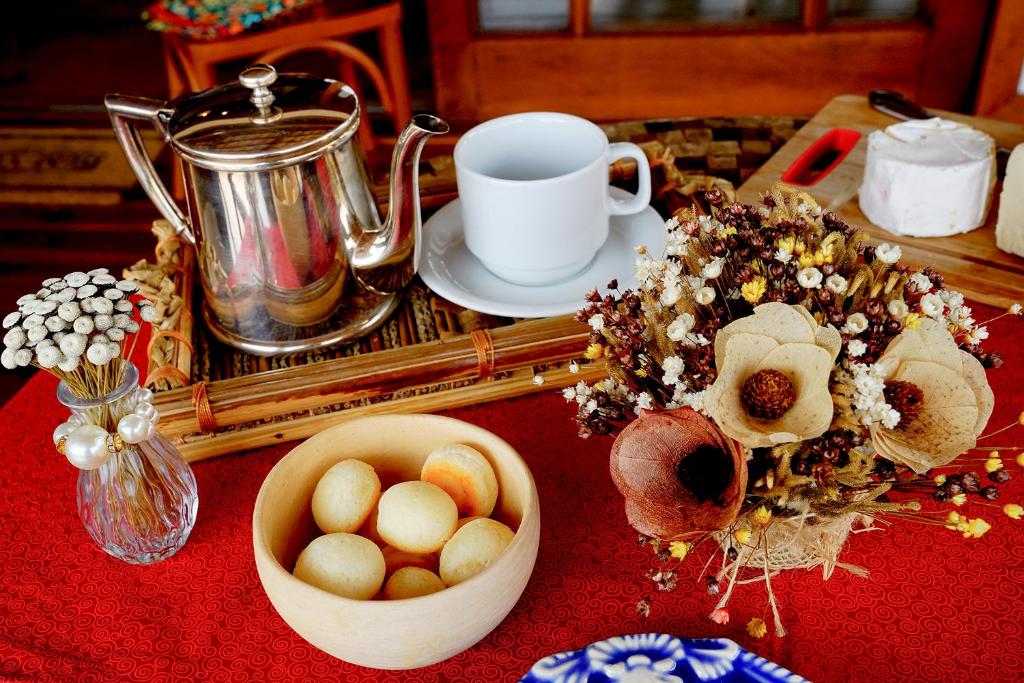 a table topped with a cup and a bowl of food at Pousada Meu Talento in Alto Paraíso de Goiás
