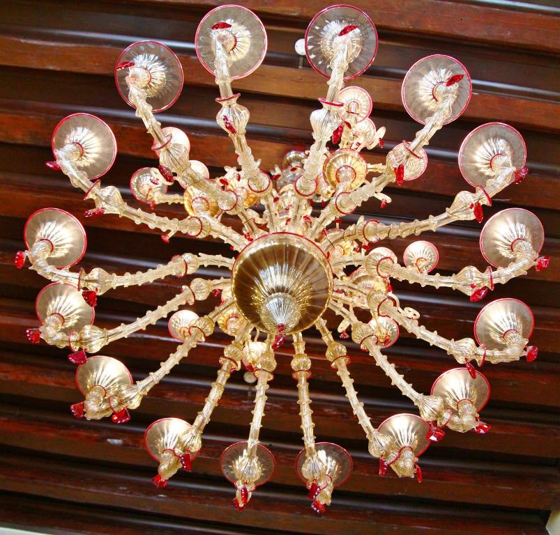 a chandelier hanging from the ceiling of a room at Pesaro Palace in Venice