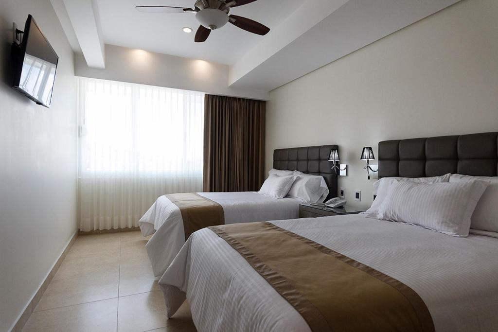 Postel nebo postele na pokoji v ubytování Hotel Maria Fernanda Inn