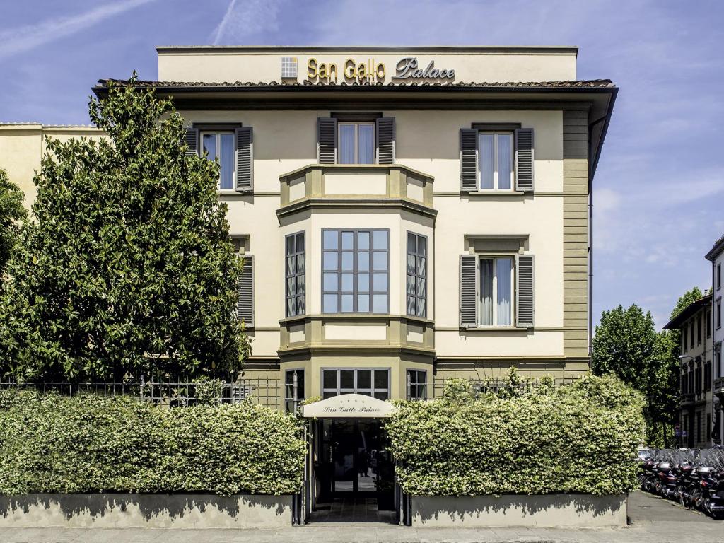 a large yellow building with a sign on it at Allegroitalia San Gallo Firenze in Florence