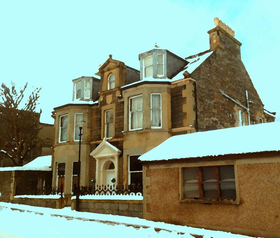 an old brick house with snow on it at Breadalbane Suites in Wick