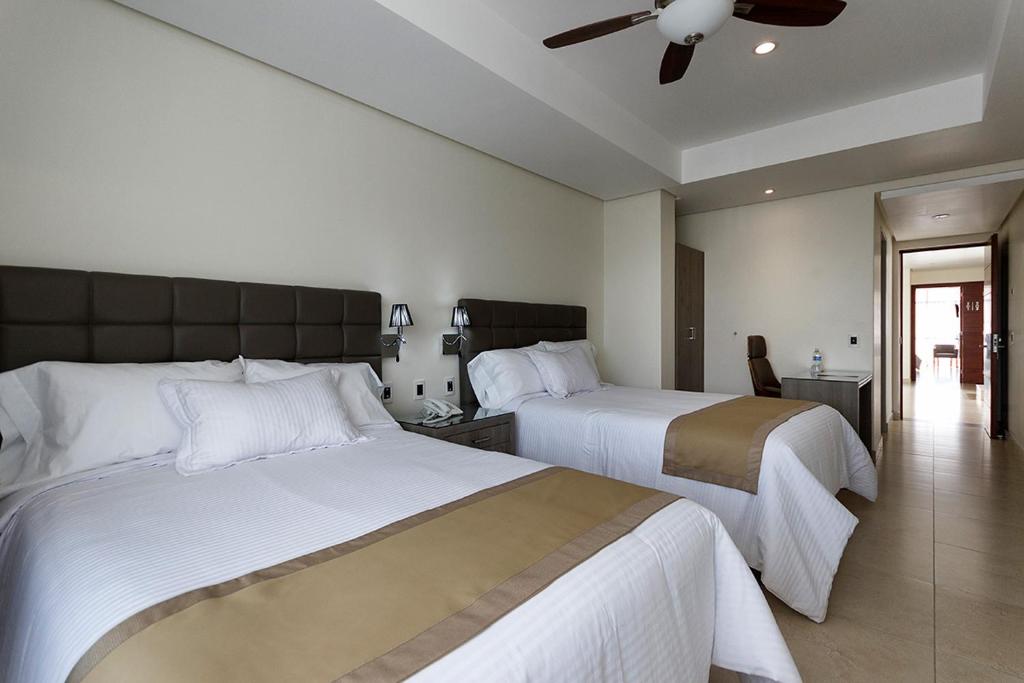 Postel nebo postele na pokoji v ubytování Hotel Maria Fernanda Inn
