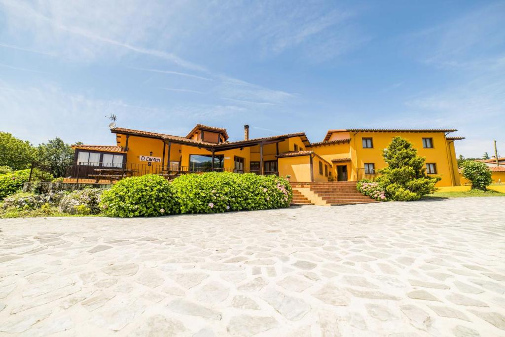 a large yellow house with a patio in front of it at El Canton in Pancar