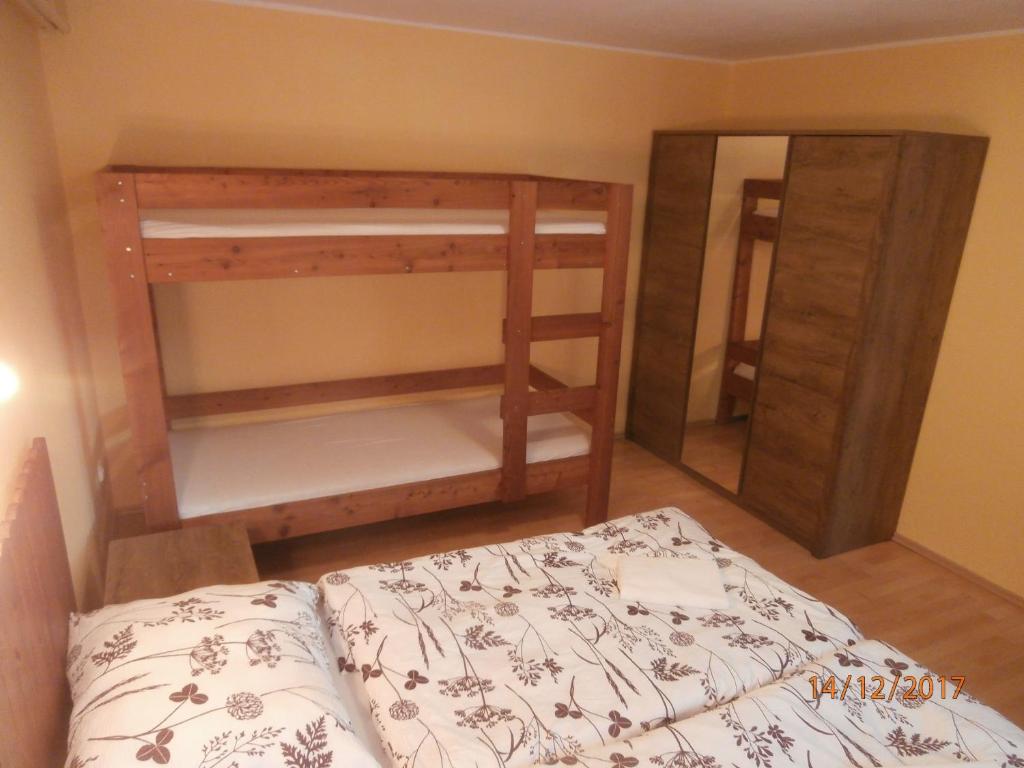 a bedroom with a bunk bed and a mirror at Apartman Aya in Janov nad Nisou
