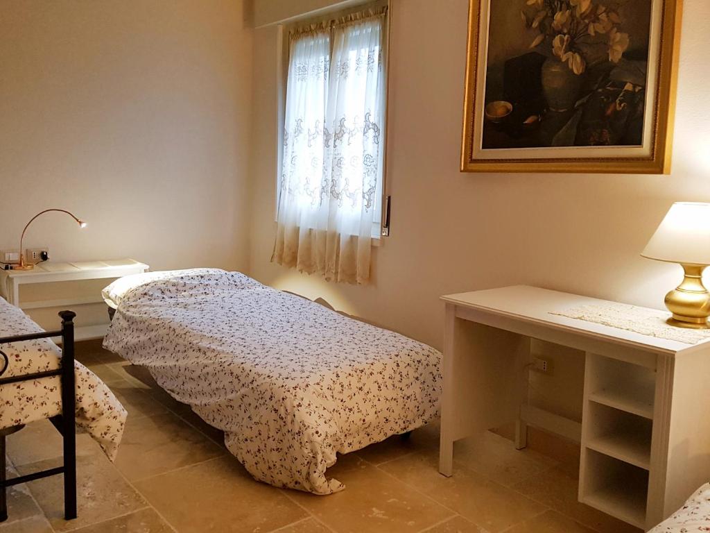 Postel nebo postele na pokoji v ubytování Foresteria Borgo Delle Grazie