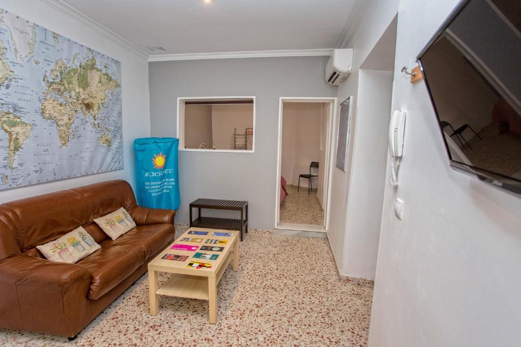 a living room with a couch and a table at Multi Apartamentos La Kasbah in Jerez de la Frontera