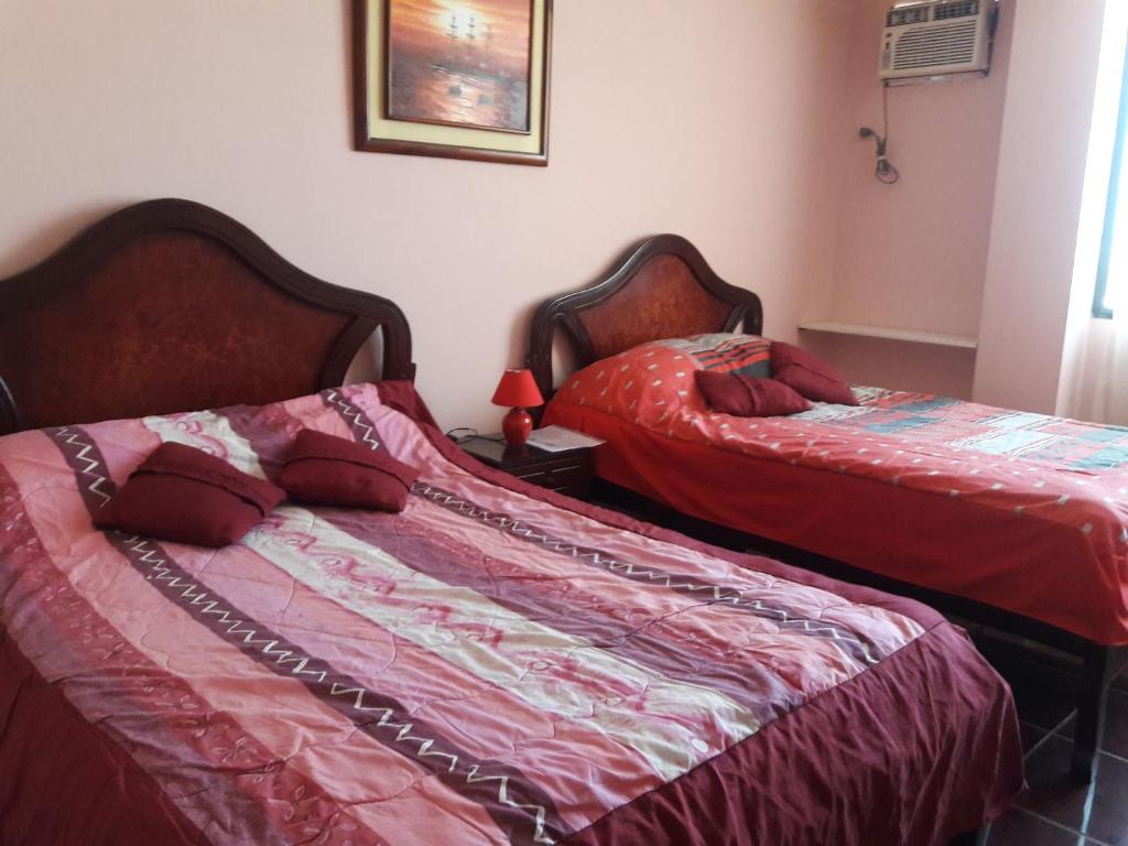Postel nebo postele na pokoji v ubytování Hostal Haziel