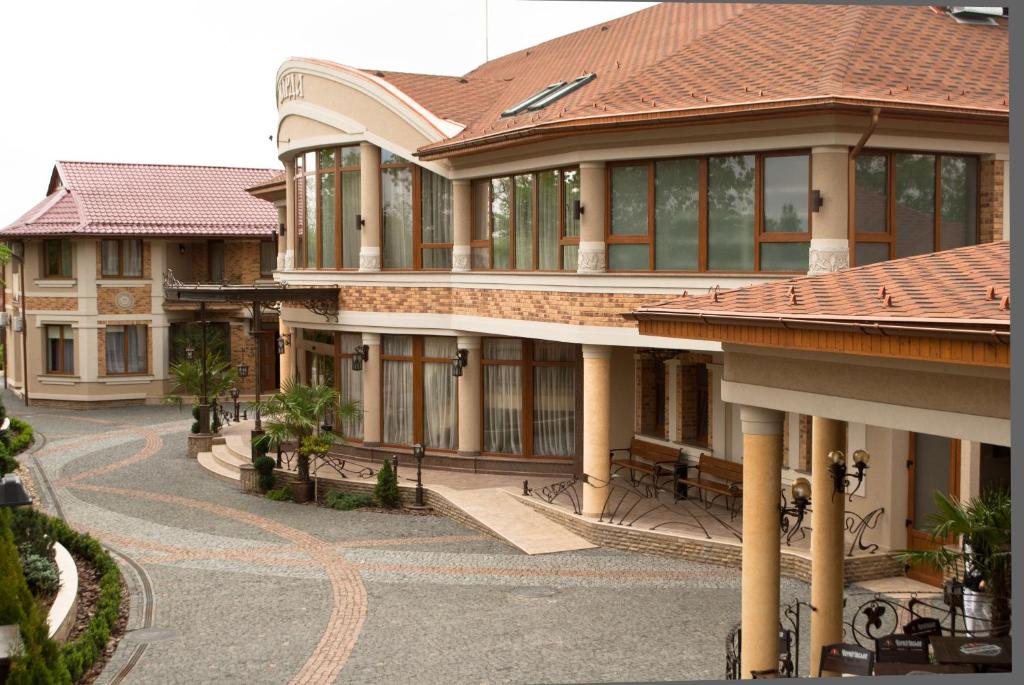 a large building with a road in front of it at Charda Hotel in Uzhhorod