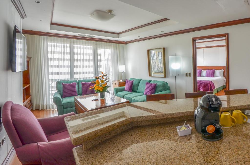 
a living room filled with furniture and pillows at Hotel Casa Veranda Guatemala in Guatemala
