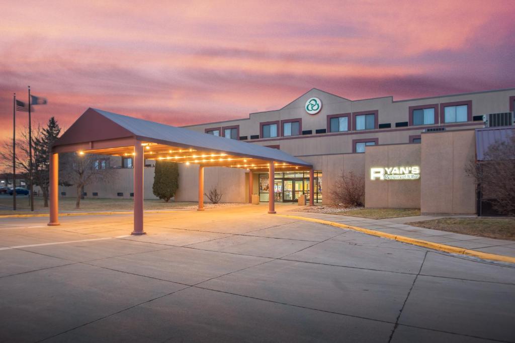 a building with a parking lot in front of it at Crossroads Hotel and Huron Event Center in Huron