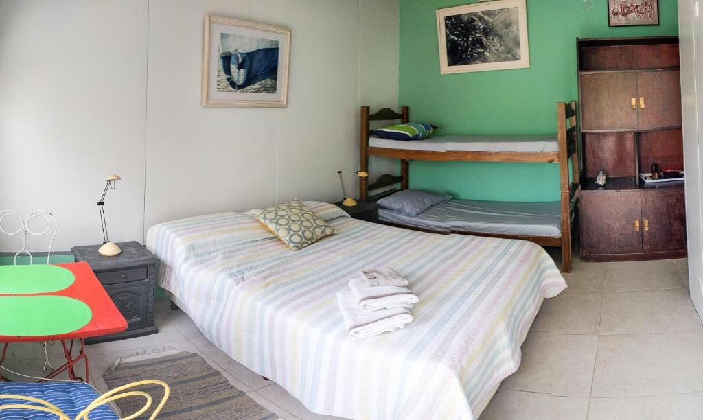 a bedroom with two beds and a bunk bed at Suites Atlantis in Punta del Este