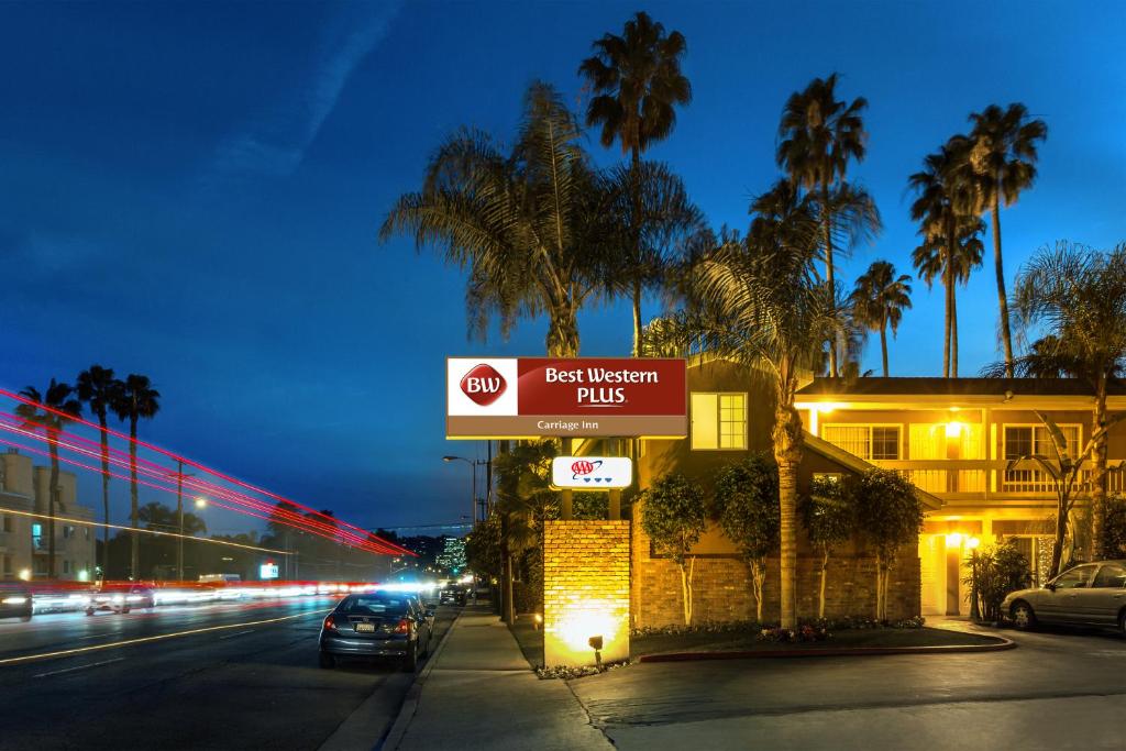 a sign for a fast food restaurant on a street at night at Best Western Plus Carriage Inn in Sherman Oaks