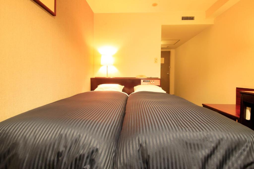 Postel nebo postele na pokoji v ubytování Quintessa Hotel Ogaki