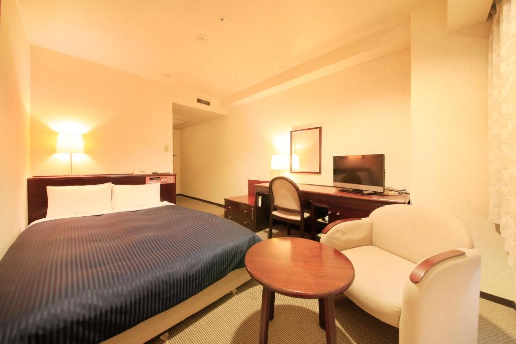 Postel nebo postele na pokoji v ubytování Quintessa Hotel Ogaki