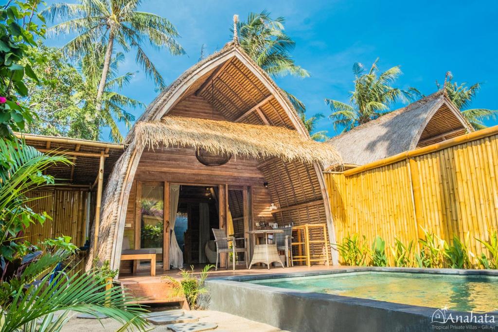a villa with a swimming pool and a resort at Anahata - Tropical Private Villas in Gili Air