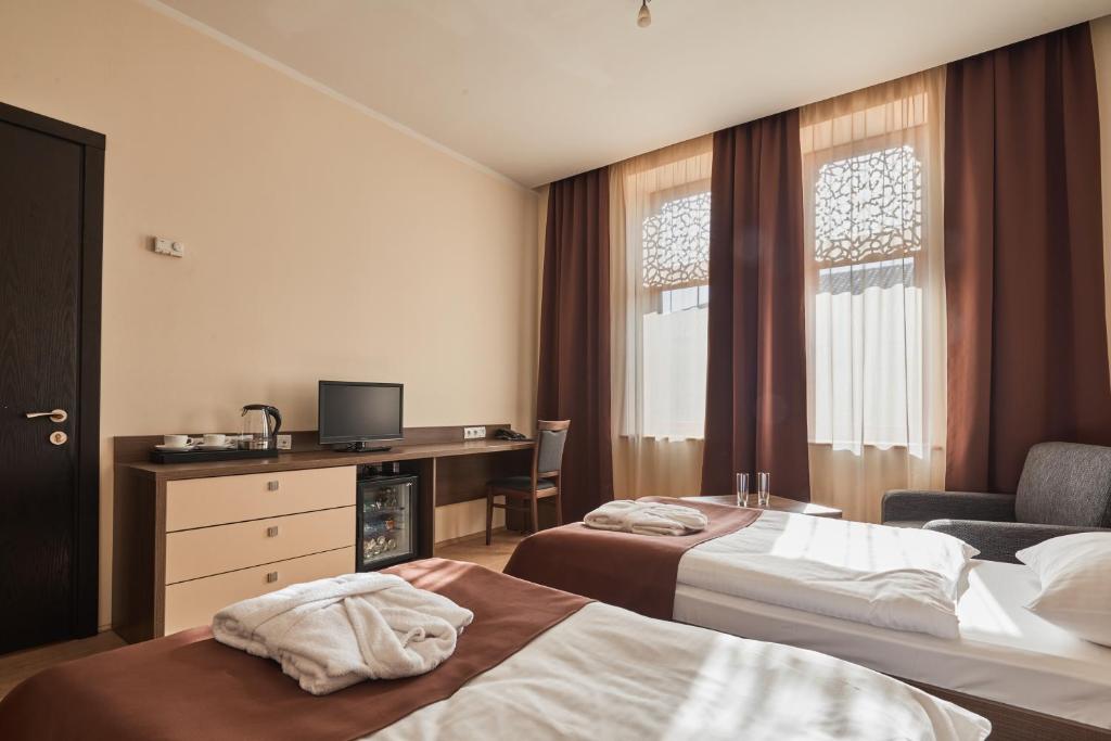 Postel nebo postele na pokoji v ubytování Hotel Gino Wellness Rabath