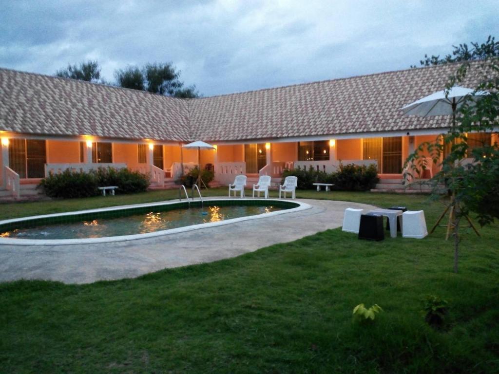 a house with a swimming pool in the yard at Baan Kub Doi Mae Chaem in Mae Chaem