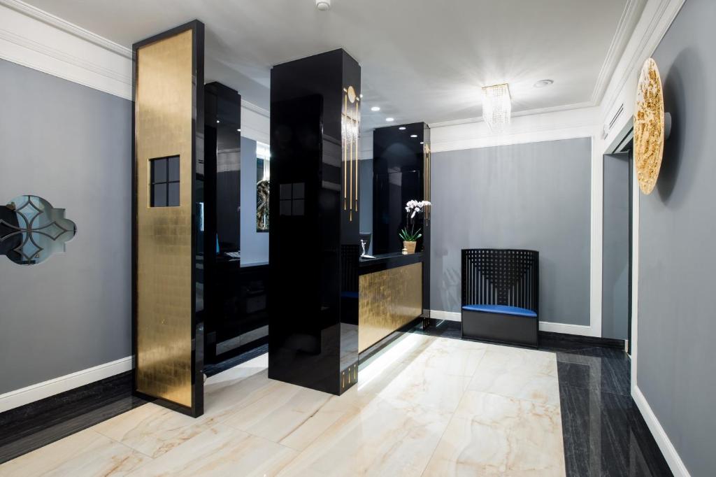 a hallway with a gold and black elevator at Art Hotel Orologio in Bologna