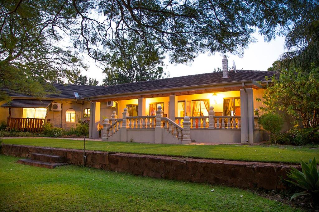 a house with its lights on in the yard at Bush Lovers Lodge in Modimolle