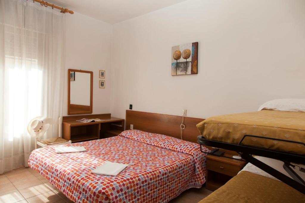 Posteľ alebo postele v izbe v ubytovaní Hotel Taormina