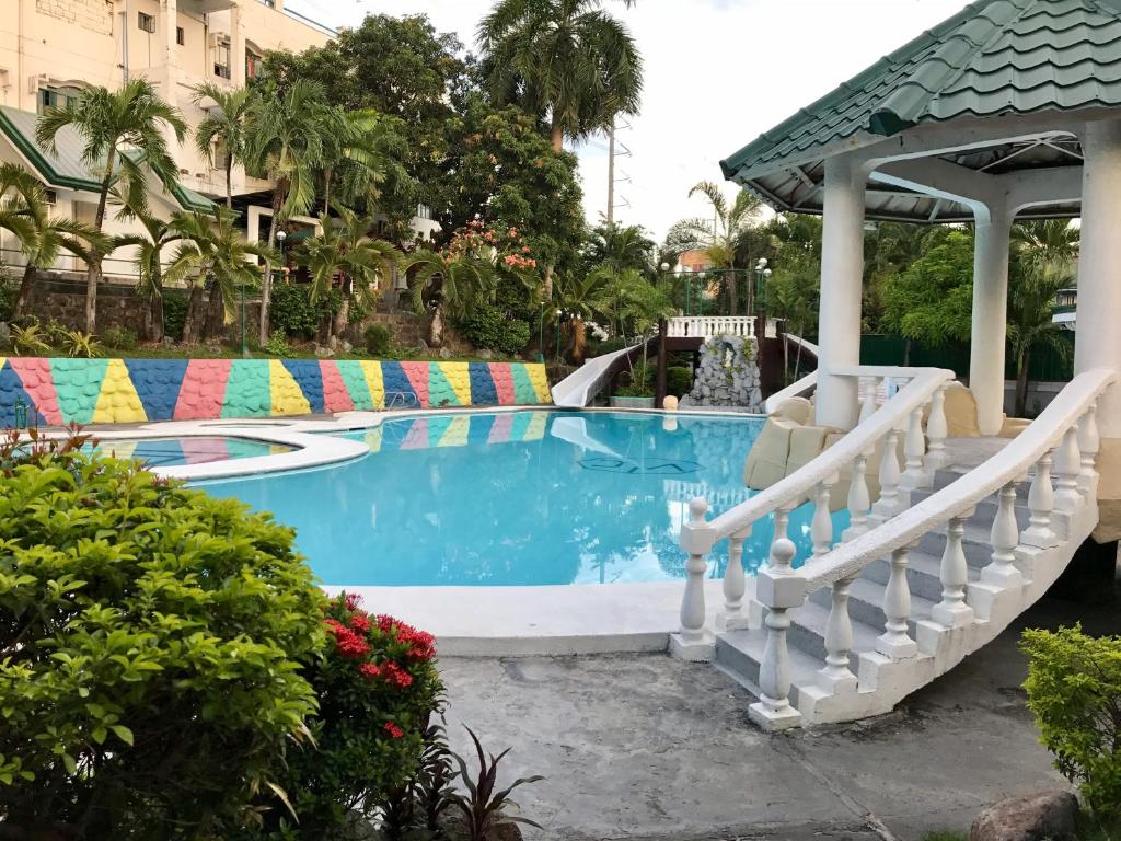 a pool at a resort with a slide at V Resort Dasma in Dasmariñas