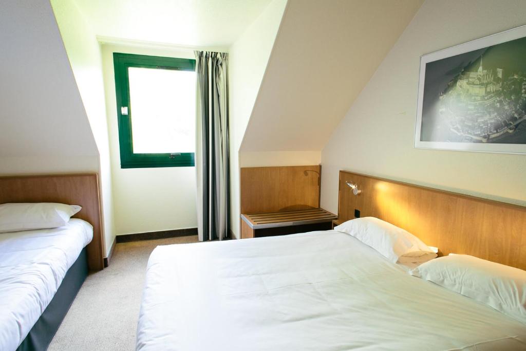 Postel nebo postele na pokoji v ubytování Hôtel Vert