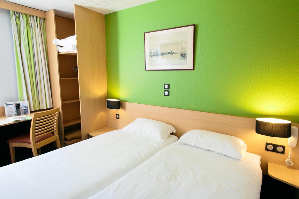 Postel nebo postele na pokoji v ubytování Hôtel Vert