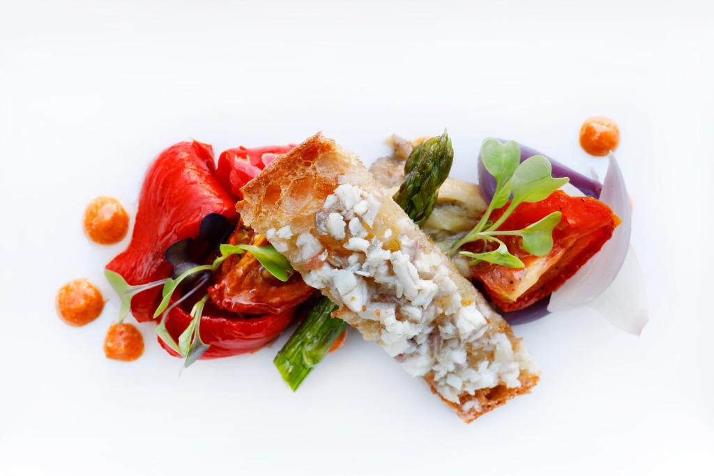 a white plate of food with rice and vegetables at Hotel Alimara in Barcelona